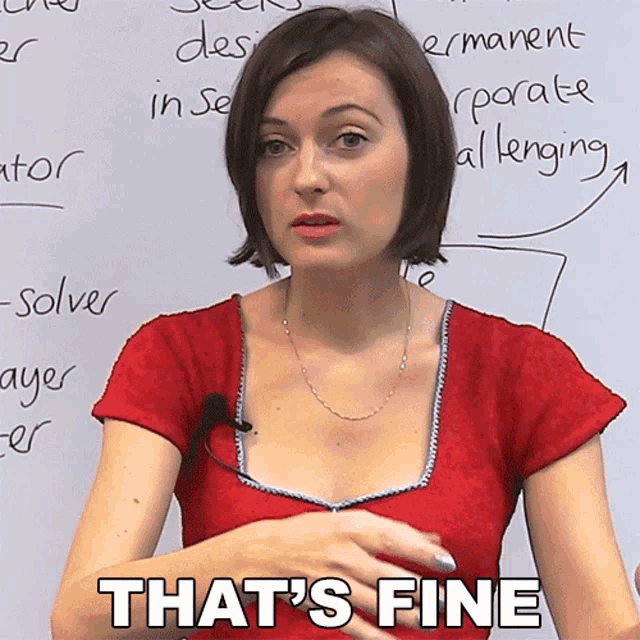 a woman stands in front of a white board with the words that 's fine written on it