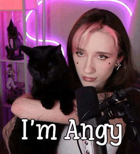 a woman holding a black cat with the words " i 'm angry " below her