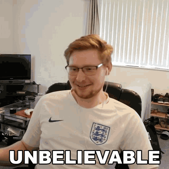 a man wearing glasses and a shirt that says unbelievable on it