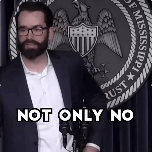 a man with glasses and a beard stands in front of a sign that says not only no