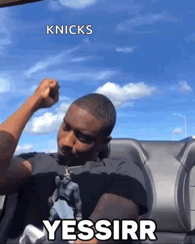 A man raises a fist near an airplane with “YESSIRR.”