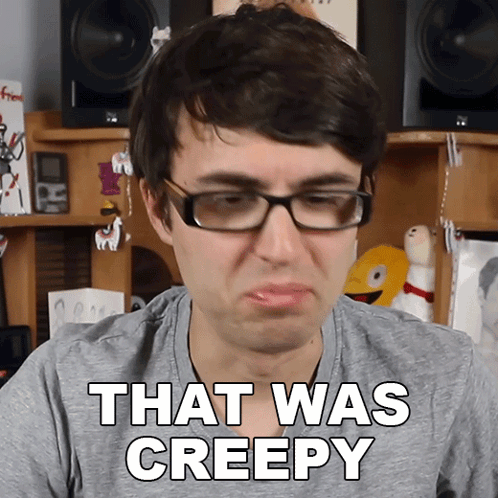 a man wearing glasses says that was creepy in a gray shirt