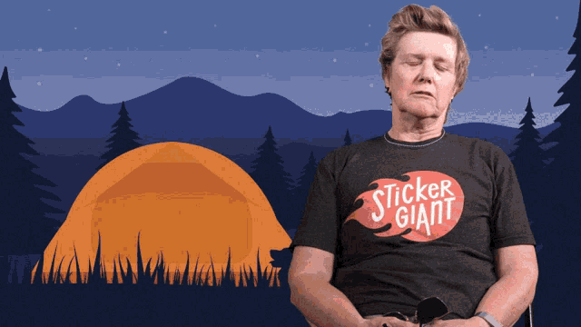a man wearing a sticker giant t-shirt sits with his eyes closed