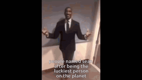 a man in a suit and tie is dancing with the caption people named sean after being the luckiest person on the planet ..