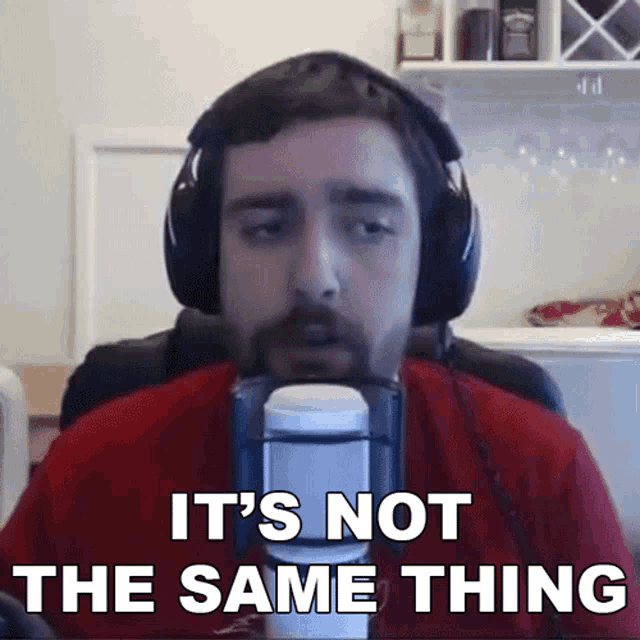 a man wearing headphones says it 's not the same thing in front of a microphone