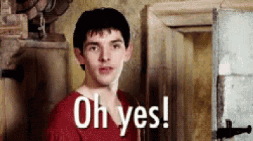 a young man in a red shirt is standing in front of a door and says oh yes .