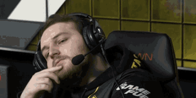 a man wearing headphones and a shirt that says game fury on it