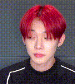 a close up of a person 's face with red hair .