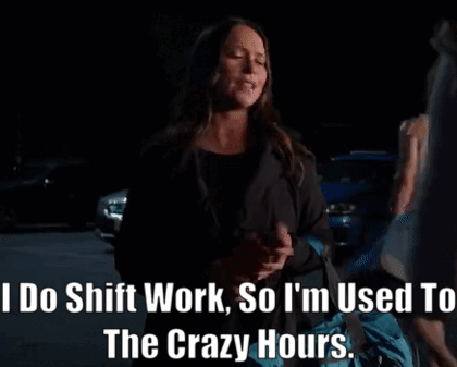 a woman is standing in a dark parking lot talking about shift work .