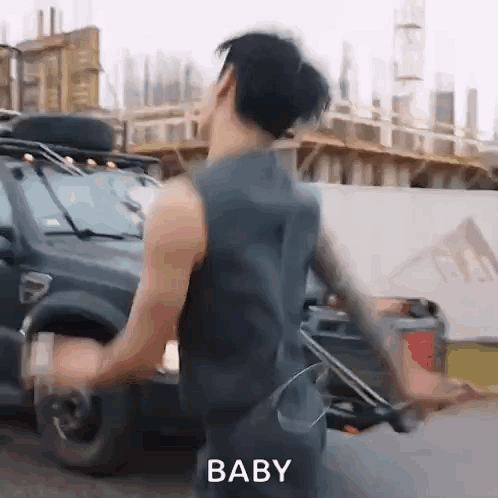 A man runs away from a parked vehicle with “BABY” text at the bottom.