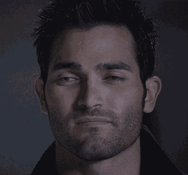 a man with a beard has his eyes closed