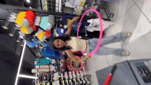 a woman in a store with a pink hula hoop