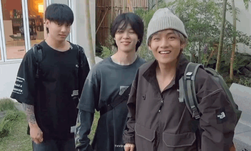 a group of young men are posing for a picture and one of them is wearing a north face jacket