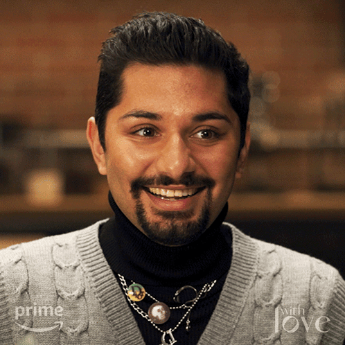 a man with a beard wearing a sweater that says prime