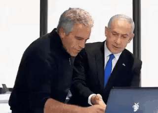 two men are looking at a laptop computer together .