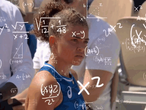 a girl stands in front of a chalkboard with math equations written on it