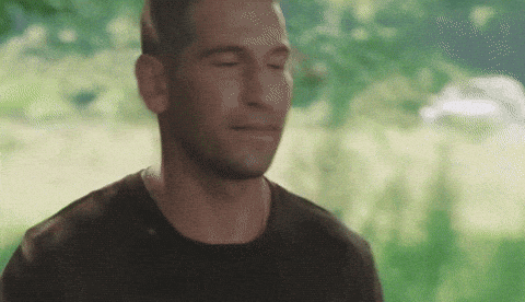 a man with his eyes closed is wearing a black t-shirt