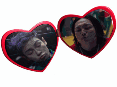 two red heart shaped mirrors with a man and a woman on them