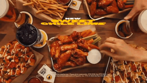 a buffalo wild wings ad shows a table full of food and drinks
