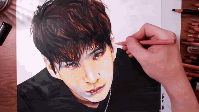 a person is drawing a portrait of a man with blue eyes