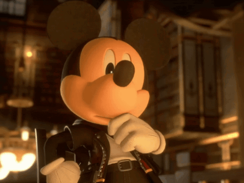 a close up of mickey mouse holding a gun in a dark room