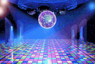 a disco ball hangs from the ceiling above a colorful dance floor