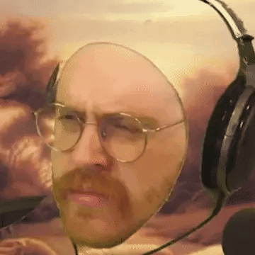 a man with glasses and a beard wears headphones