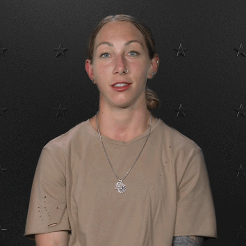 a woman says here we go again in front of a black background with stars