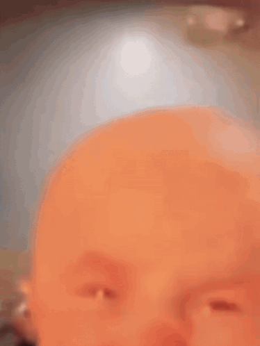 a close up of a baby making a funny face