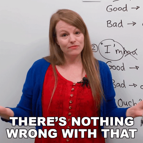 a woman stands in front of a white board with the words there 's nothing wrong with that written on it