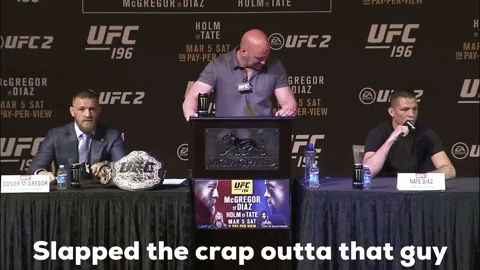 three men sitting at a table with a sign that says ufc 196