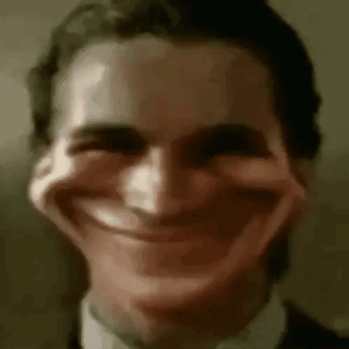 A distorted man’s face wears a stretched, unsettling smile.