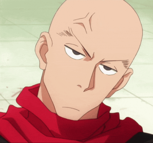 a bald man with a red scarf around his neck looks angry