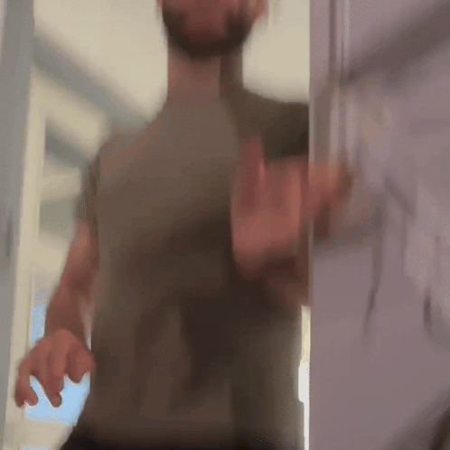A blurred person recoils as if startled by a jump scare.