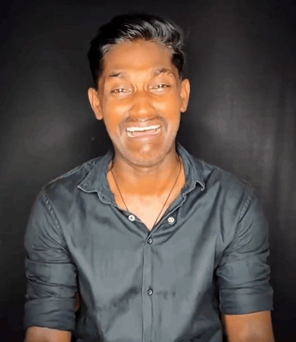 A man grimaces with an emotional, pained expression.
