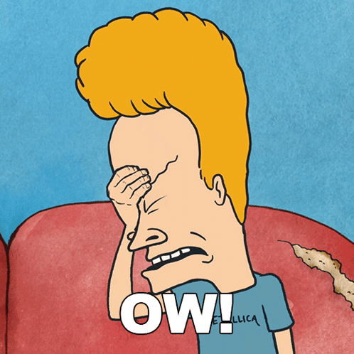 Beavis leans forward with a strained face beneath the caption “OW!!!”