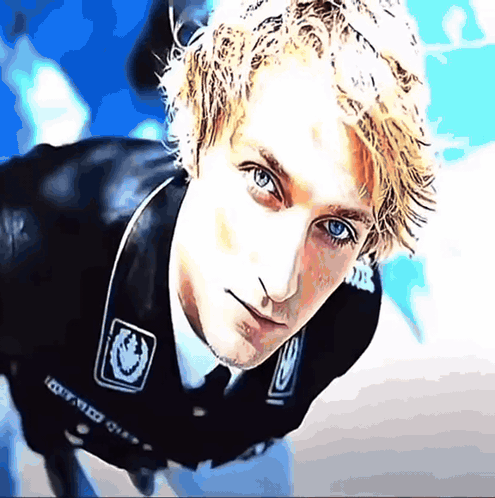a close up of a man 's face with a sticker on his jacket that says ' i got med ' on it