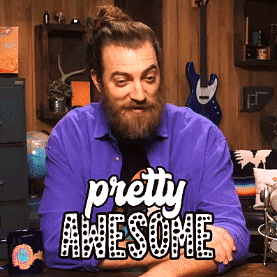 a man with a beard is sitting at a table with the words pretty awesome above him