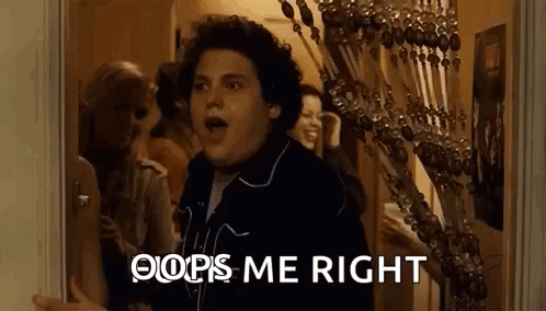 a man is standing in a hallway with his mouth open and the words `` oops me right '' behind him .