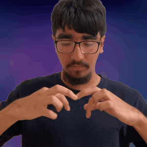 a man with glasses and a beard making a heart with his hands