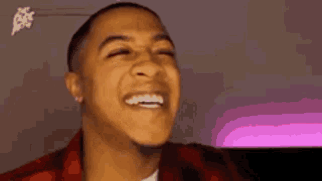 Man smiles tensely with an uncomfortable expression.