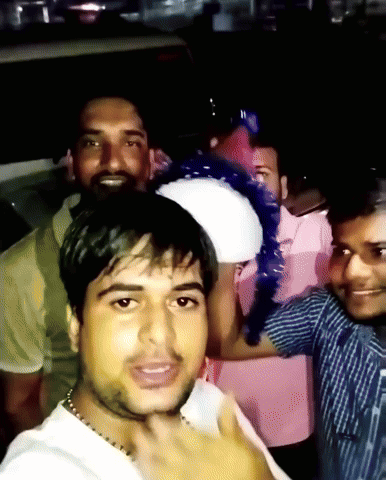 a group of men are posing for a picture and one of them is wearing a white shirt