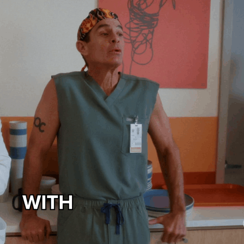 a man in scrubs stands in front of a sign that says ' with '
