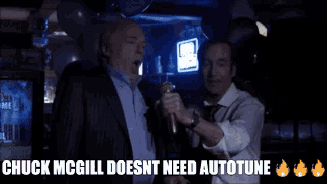 two men singing into a microphone with the words chuck mcgill does n't need autotune below them