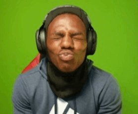 a man wearing headphones and a scarf making a funny face .