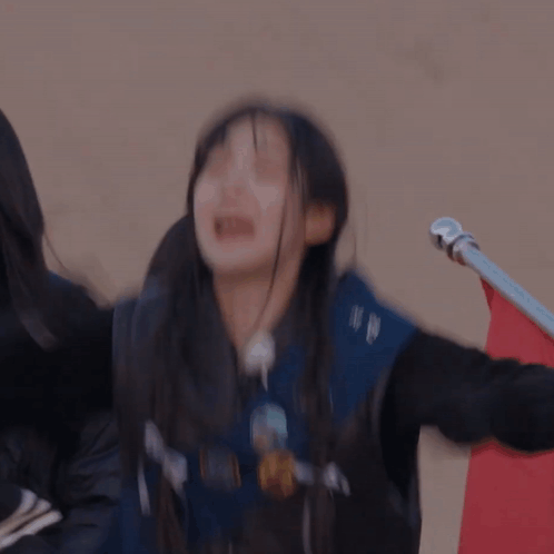 a blurry picture of a girl wearing a jacket that says nm