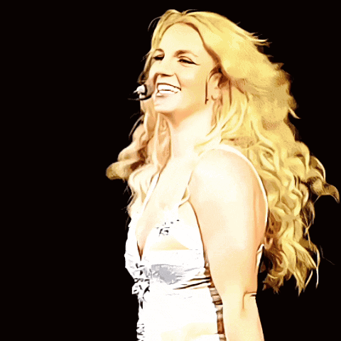 a blonde woman in a white dress is smiling