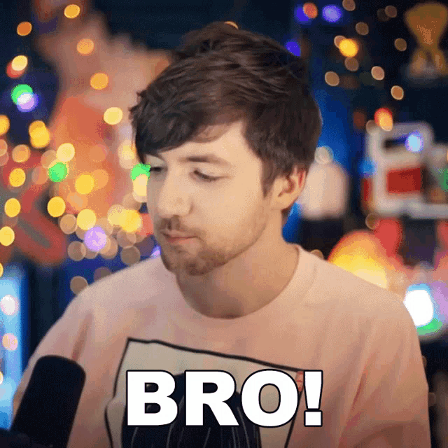 a man wearing a pink shirt says bro
