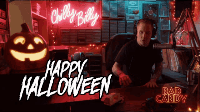 a man sitting in front of a neon sign that says chilly billy happy halloween