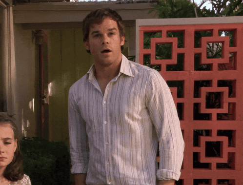Dexter Morgan stands in a doorway looking startled and unsure.